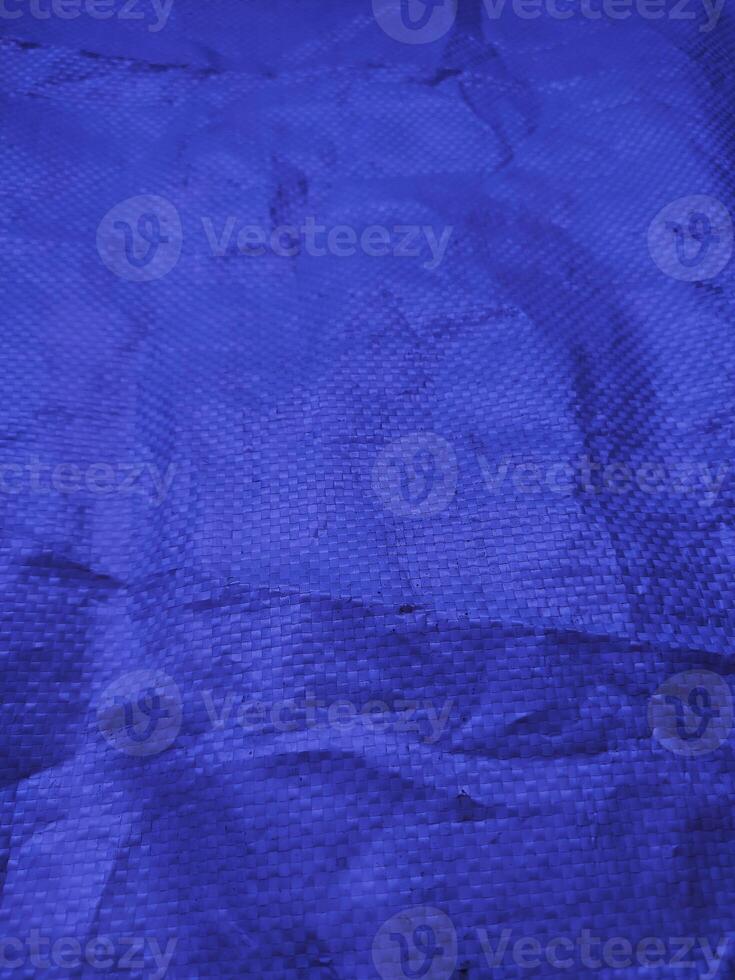 Blue sack texture and pattern. Arranged on a simple blue background. For banners, website covers photo