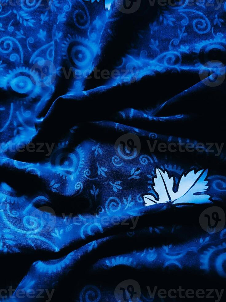 Blue fabric pattern and background with leaf design photo