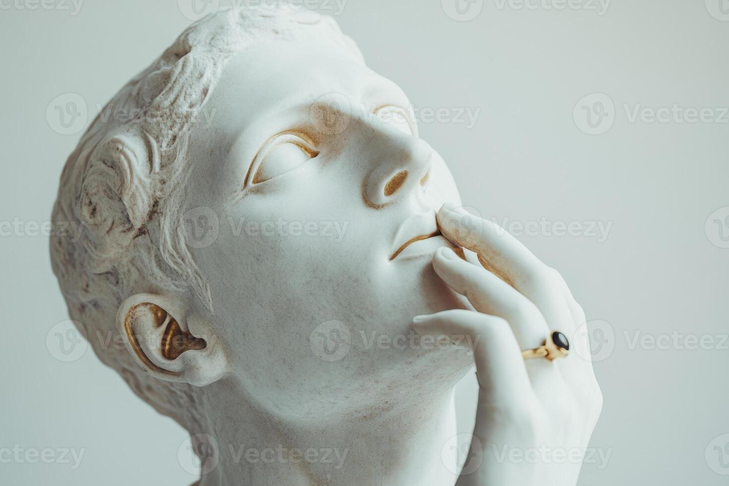 White gypsum sculpture of human touching face with finger photo