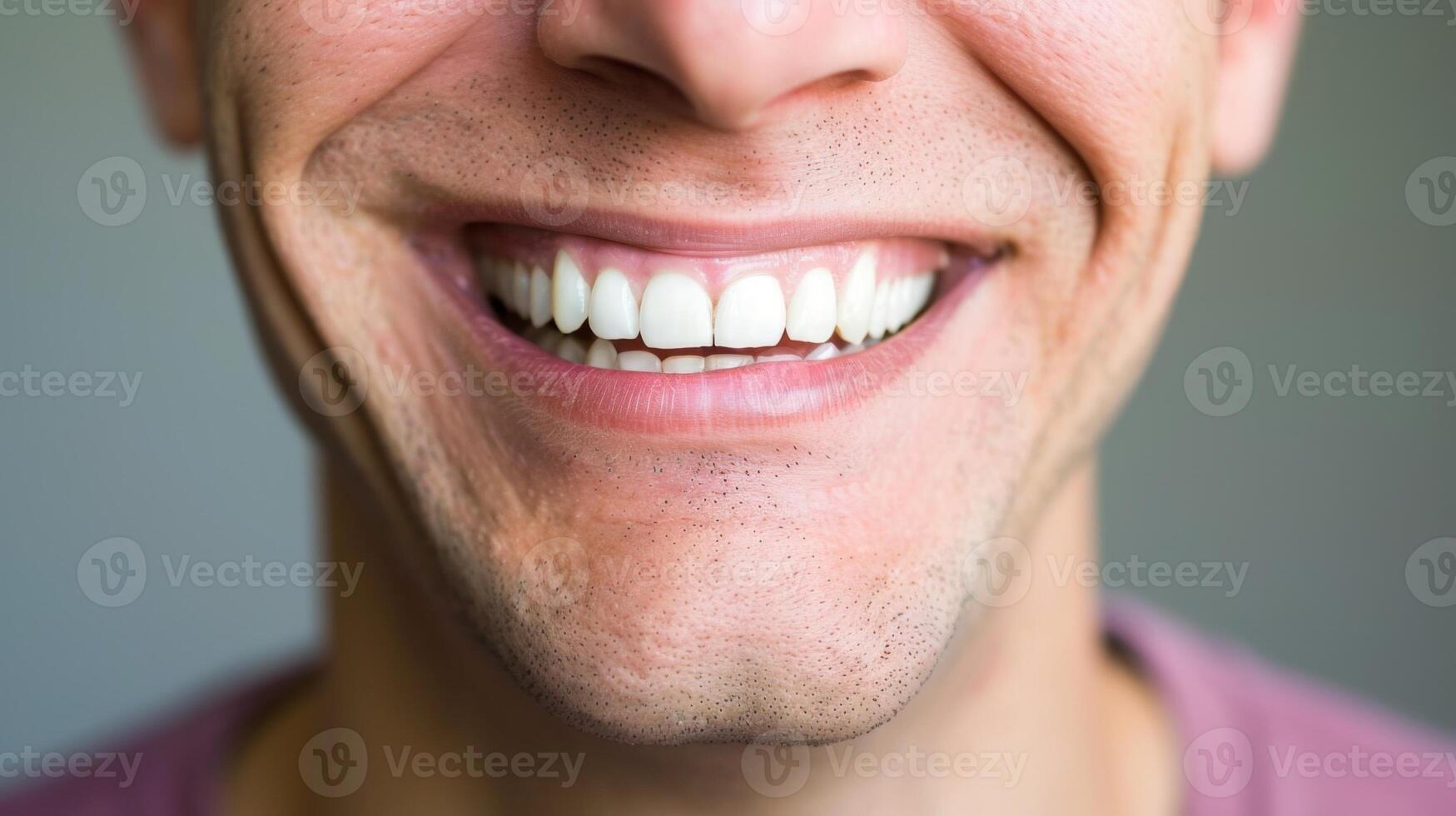 Young man smiling showing healthy white teeth photo
