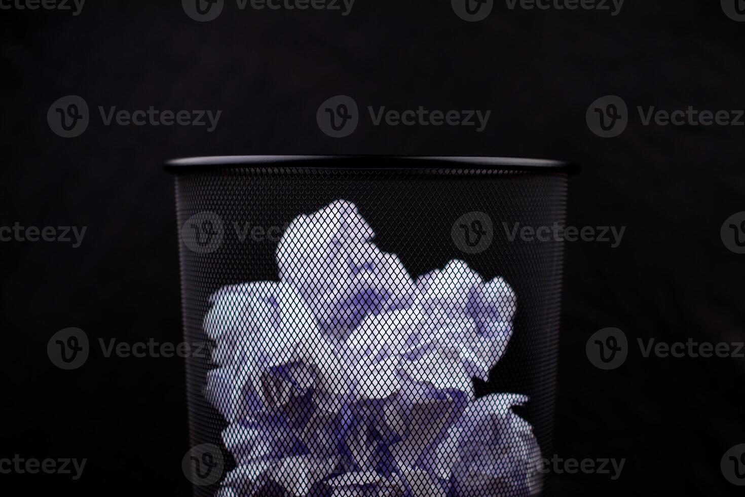 Waste paper basket, throwing waste into the trash, crumpled white paper, pile of waste paper photo