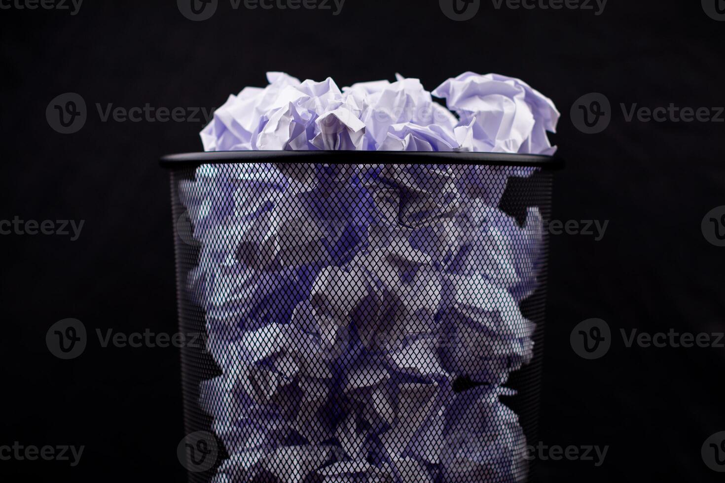 Trash can and scrap paper Photo of black trash can and white crumpled paper
