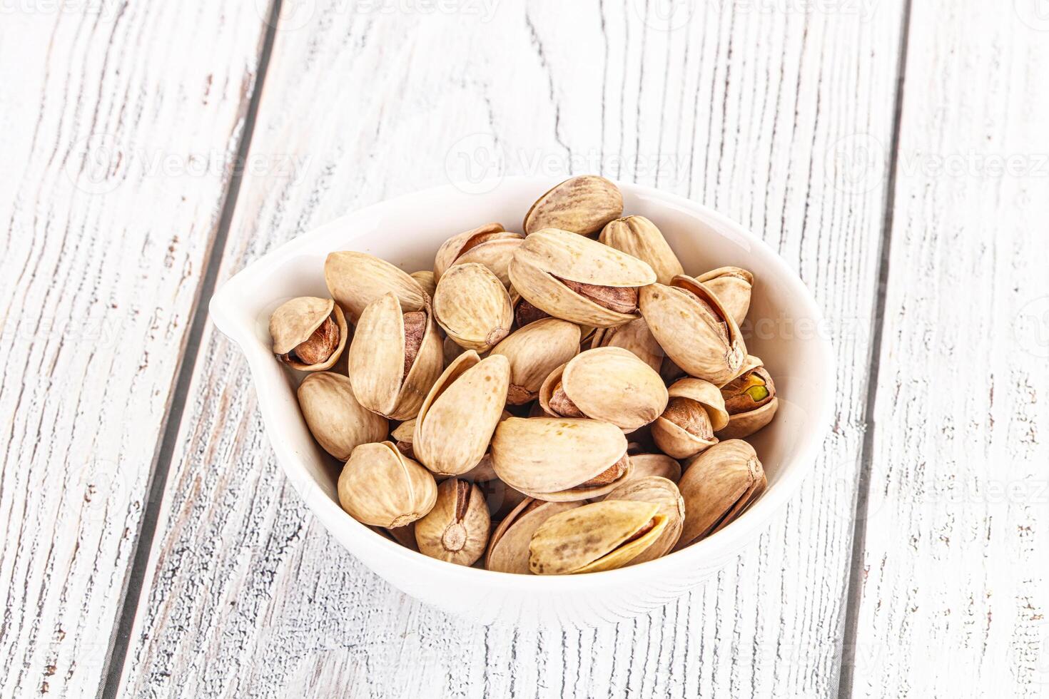 Salted tasty pistachio nuts heap photo