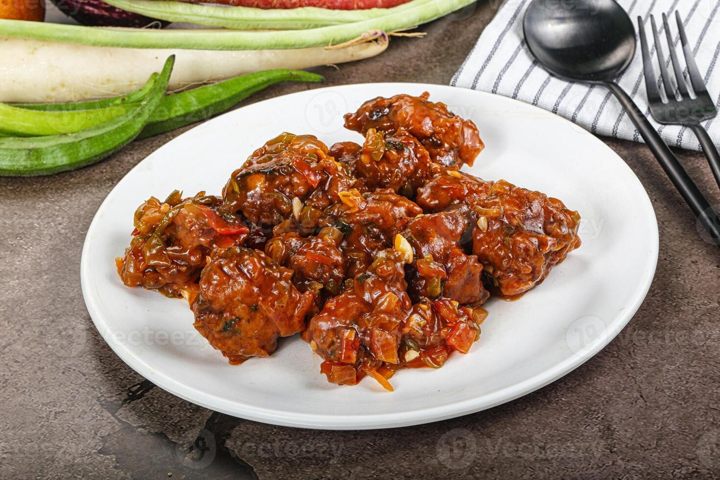 Manchurian chicken with sauce and spices photo