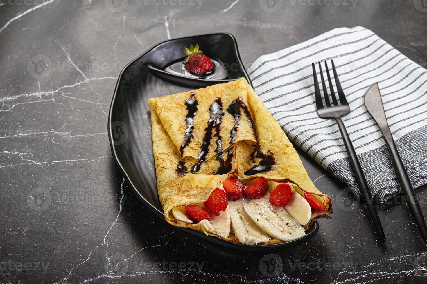 Sweet pancake with banana and strawbeery photo