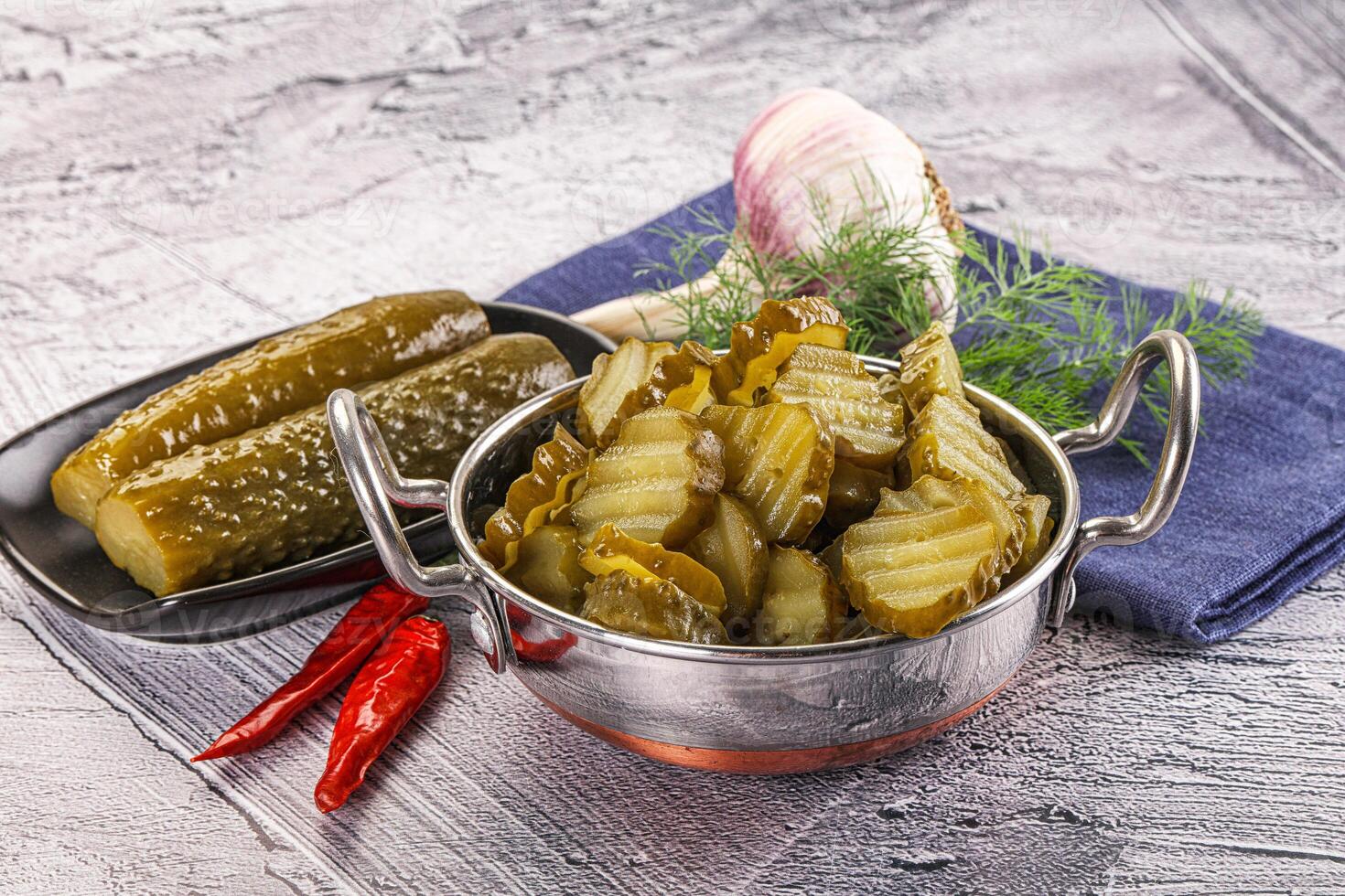 Sliced marinated cucumbers in the bowl photo