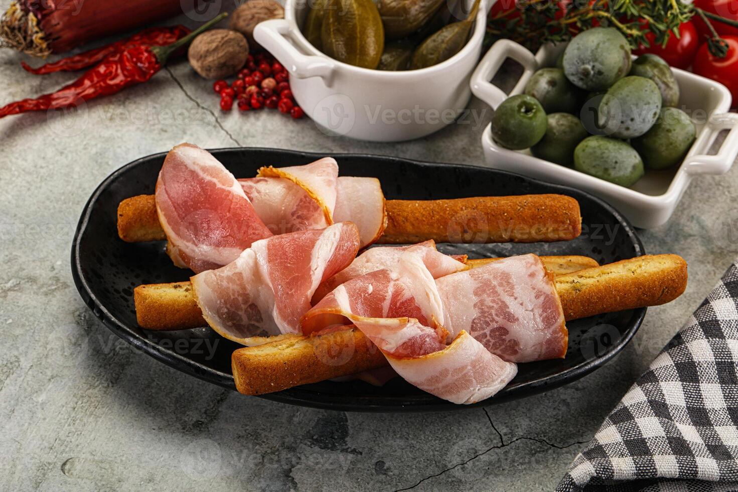 Antipasti - Grissini with pork bacon photo
