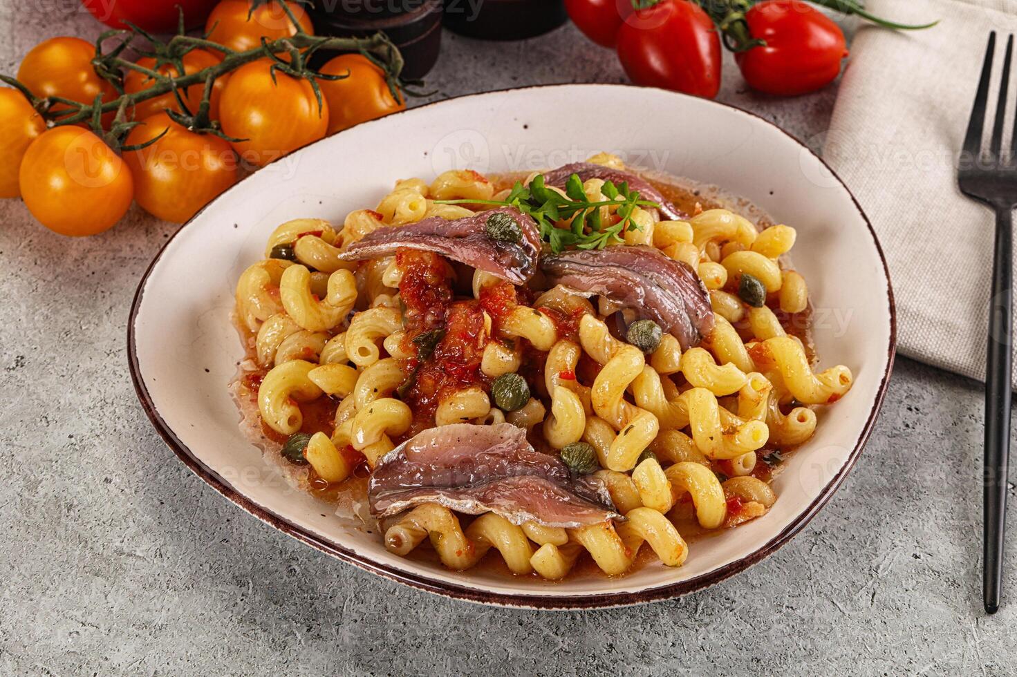 Italian pasta cellentani with anchovy photo
