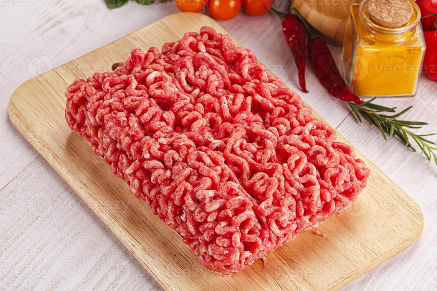 Raw minced beef meat over board photo