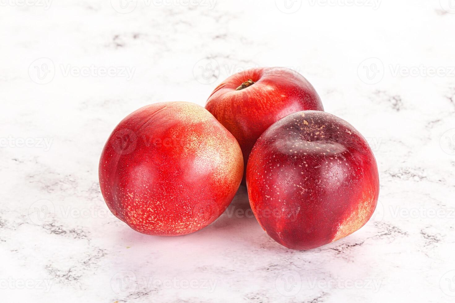 Ripe sweet juicy nectarines heap photo
