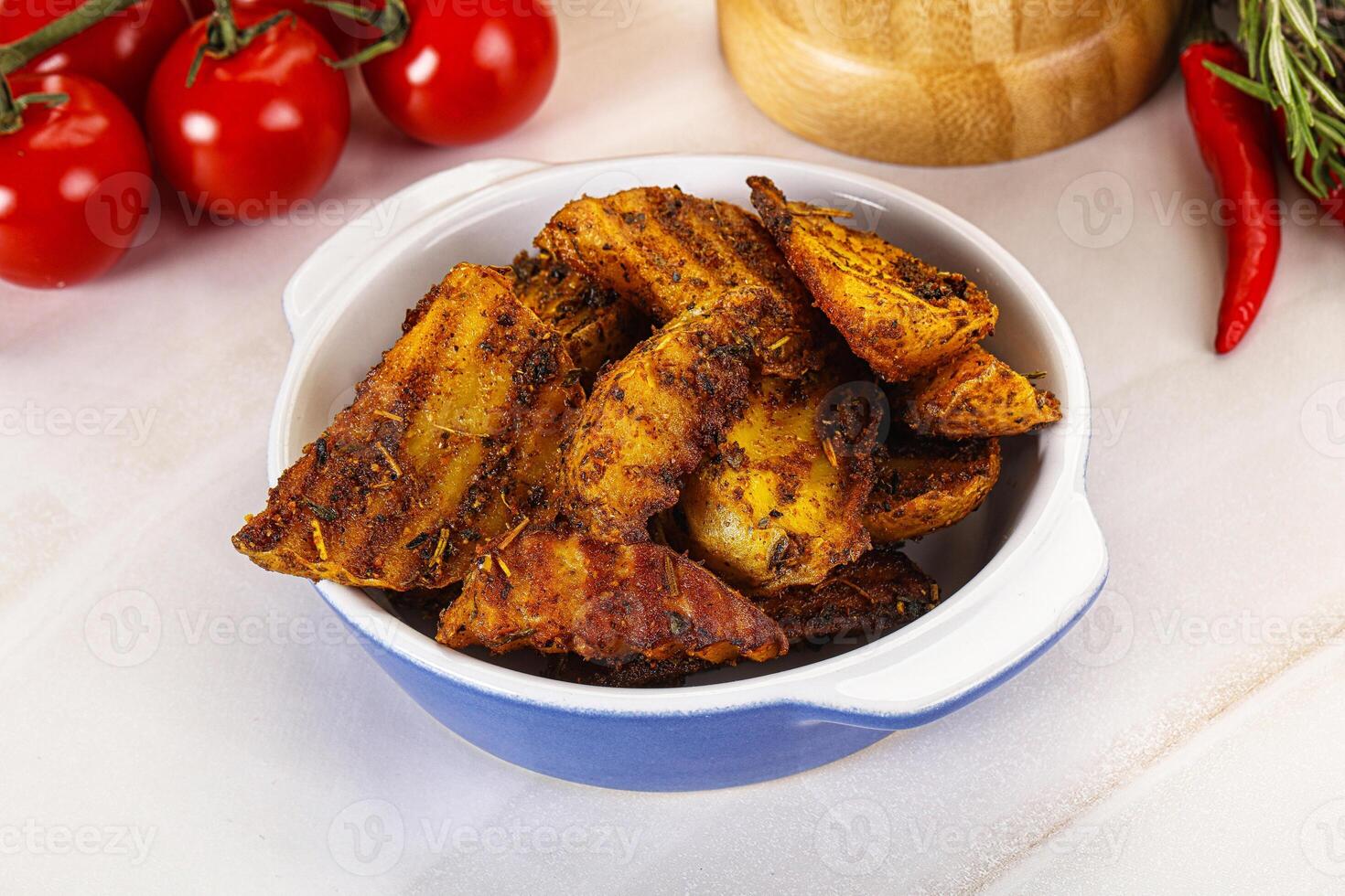 Golden baked potato Idaho with spices photo