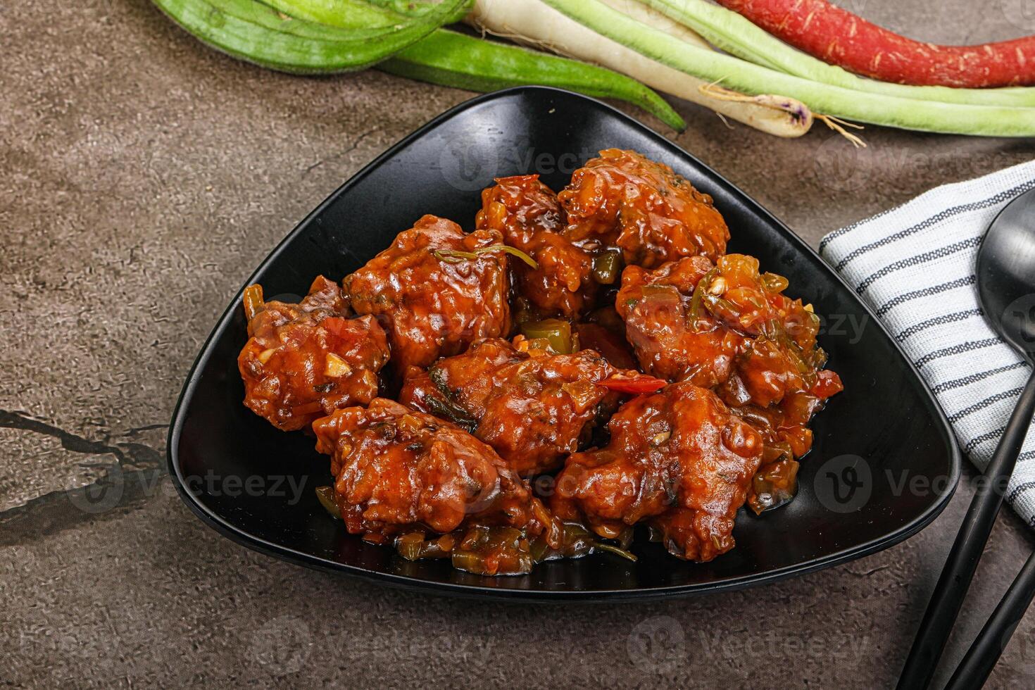 Manchurian chicken with sauce and spices photo