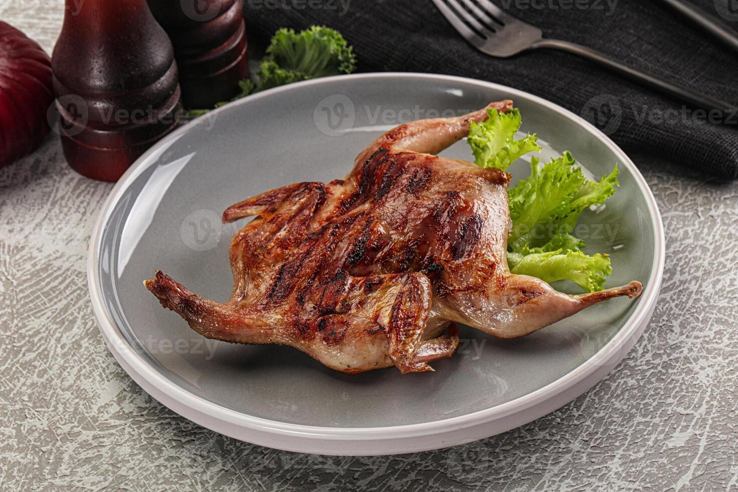 Grilled quail in the plate photo