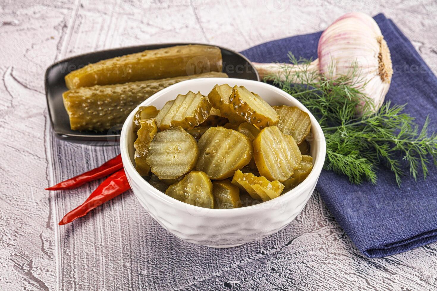 Sliced marinated cucumbers in the bowl photo