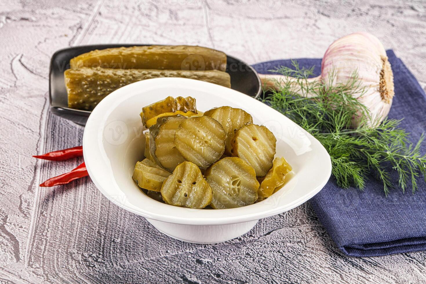 Sliced marinated cucumbers in the bowl photo