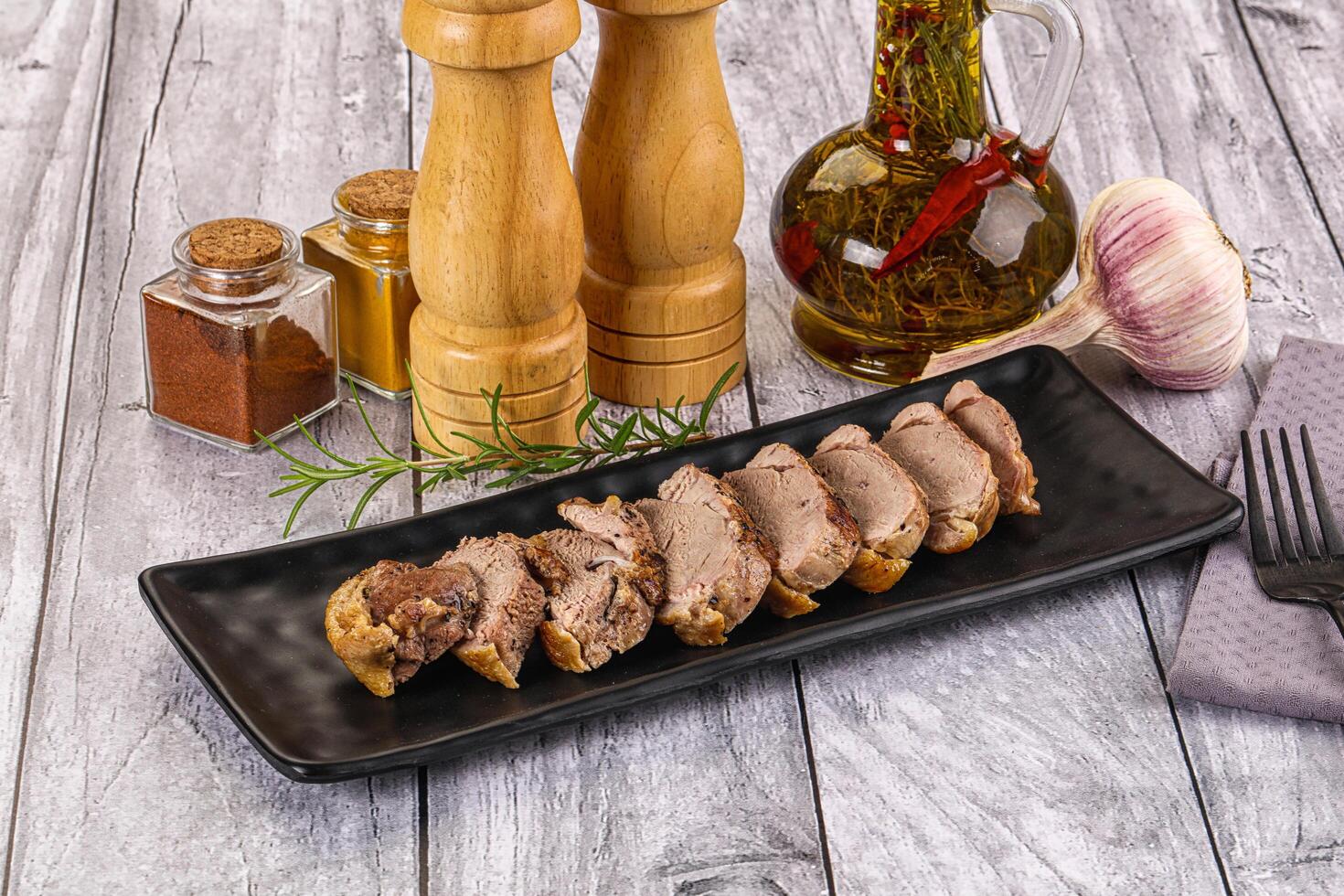 Roasted duck breast slices in the plate photo