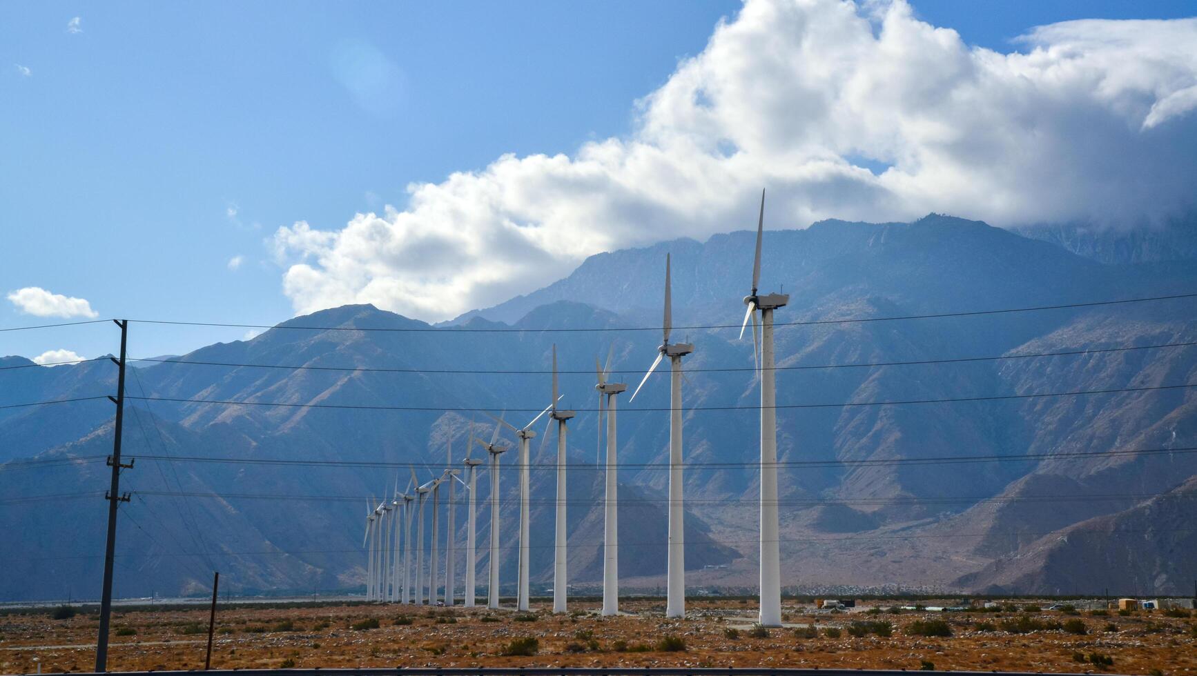 CALIFORNIA, USA - NOVEMBER 27, 2019 View of wind turbines generating electricity. Huge array of gigantic wind turbines spreading over the desert in Palm Springs wind farm, California photo