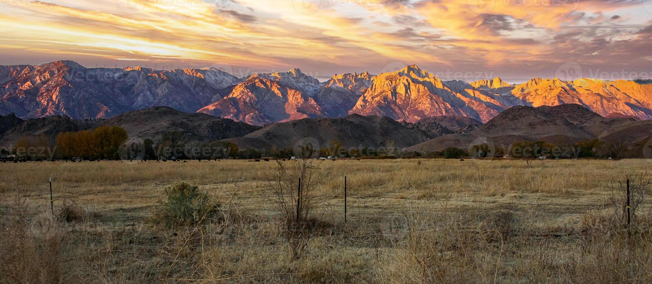 The peaks of rocky mountains with snow-capped peaks illuminated by the evening sun, Sierra Nevada Mountains, California, USA photo