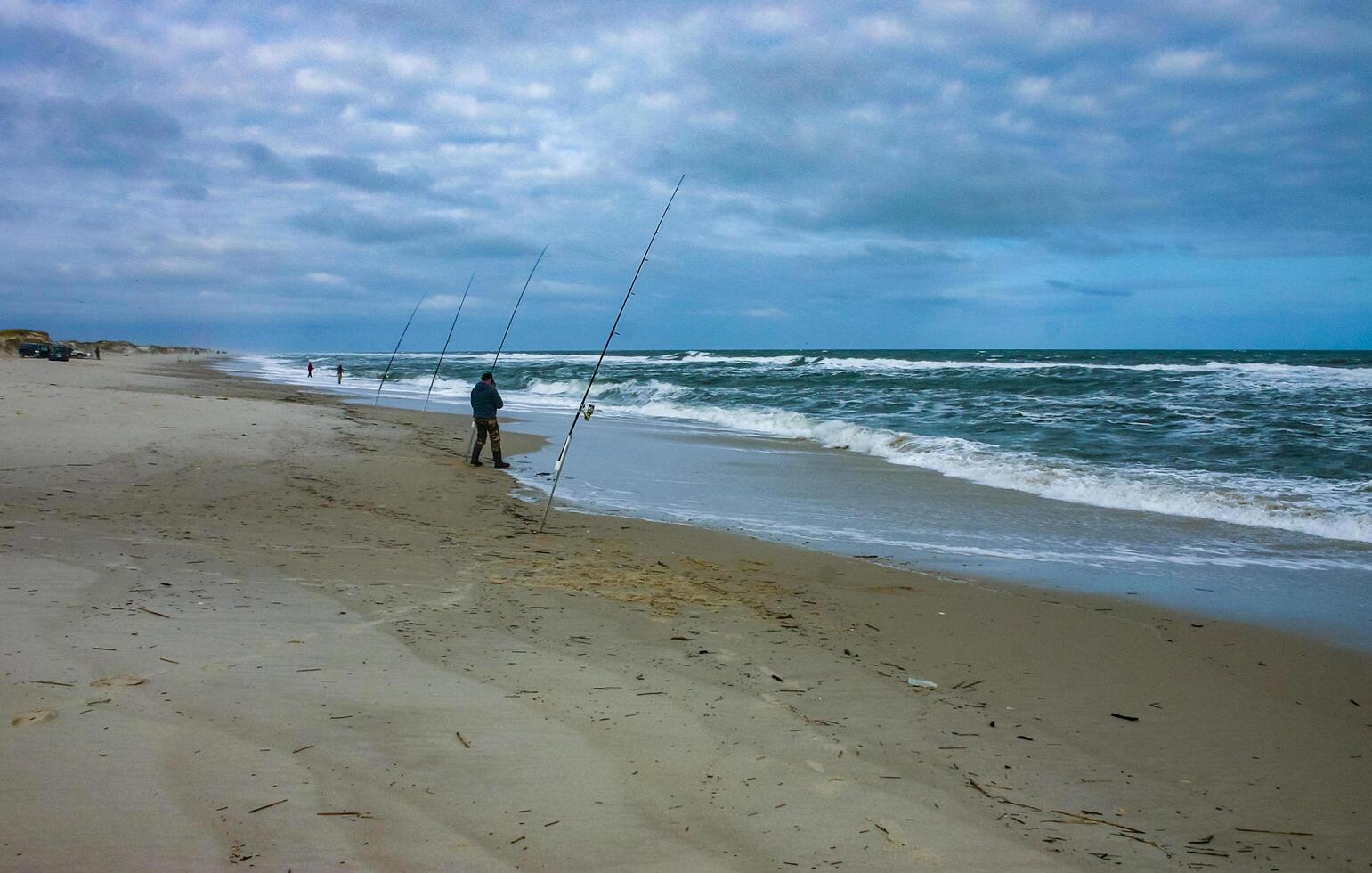 New Jersey, USA - November 19, 2009 Fishermen on the sandy shore of the Atlantic Ocean in New Jersey, USA photo