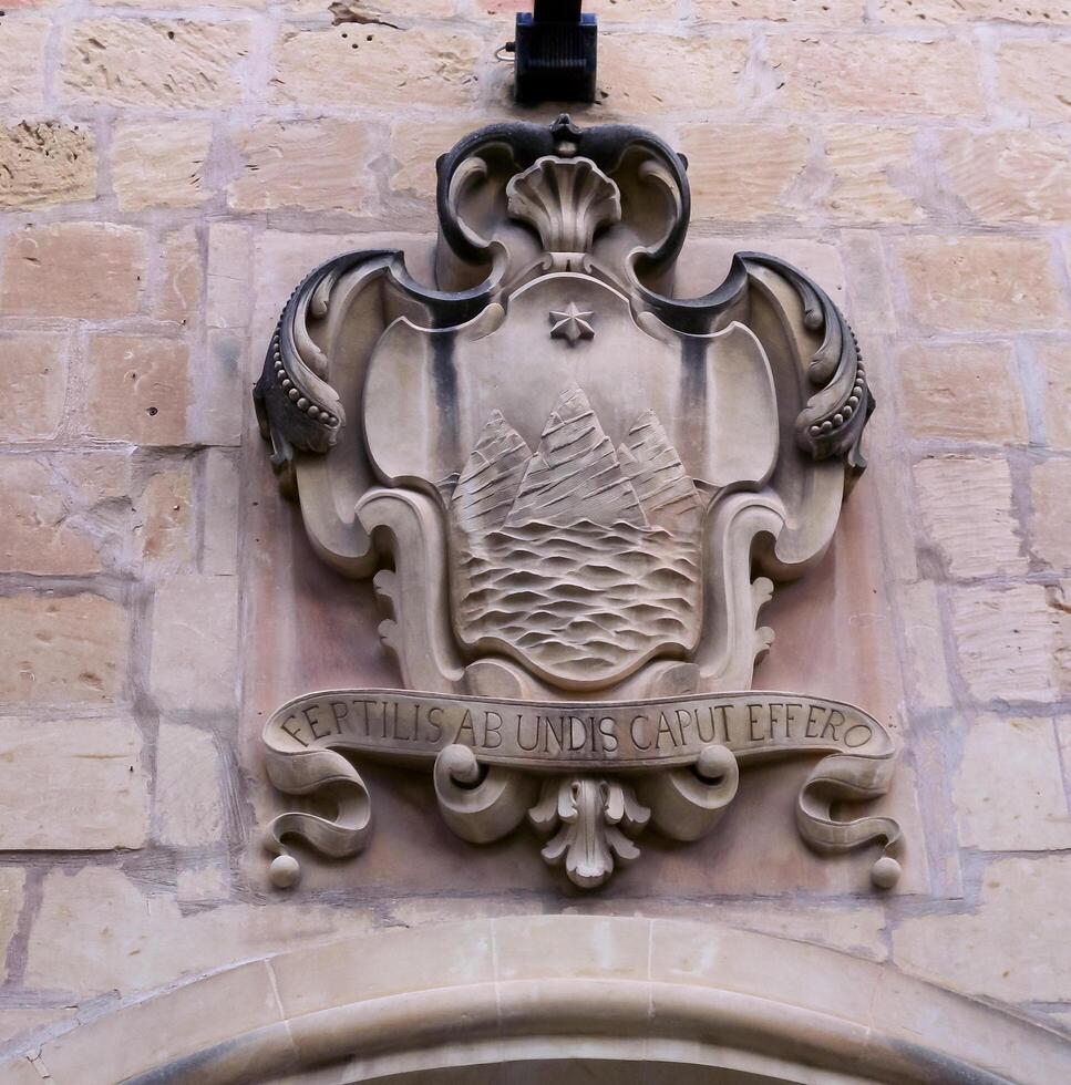GOZO, MALTA - SEPTEMBER 14, 2012 Ancient coat of arms Island of the three hills on the island of Gozo, Malta photo