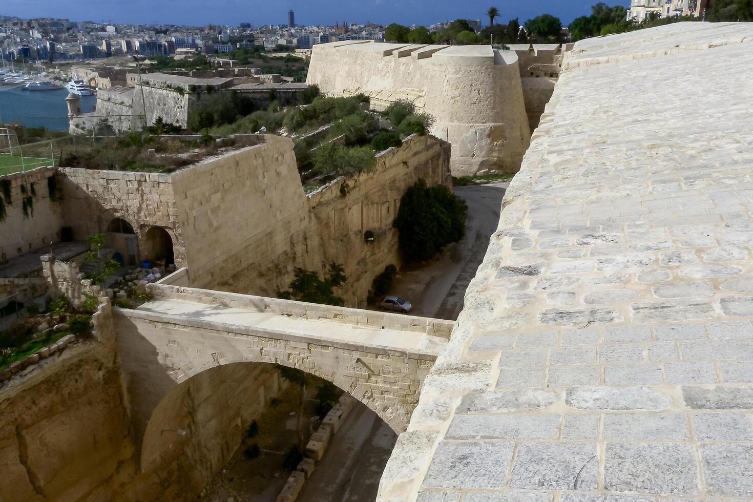 VALLETTA, MALTA - SEPTEMBER 14, 2012 View from the Valletta City Gate bridge to Valletta Ditch and St. John's Bastion in Valletta, Malta photo