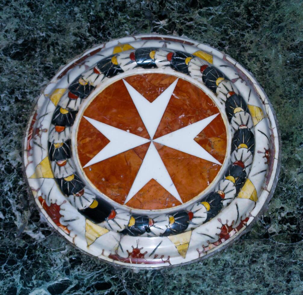 Maltese cross in marble, Chapel of St. John's Cathedral near Valletta in Malta photo