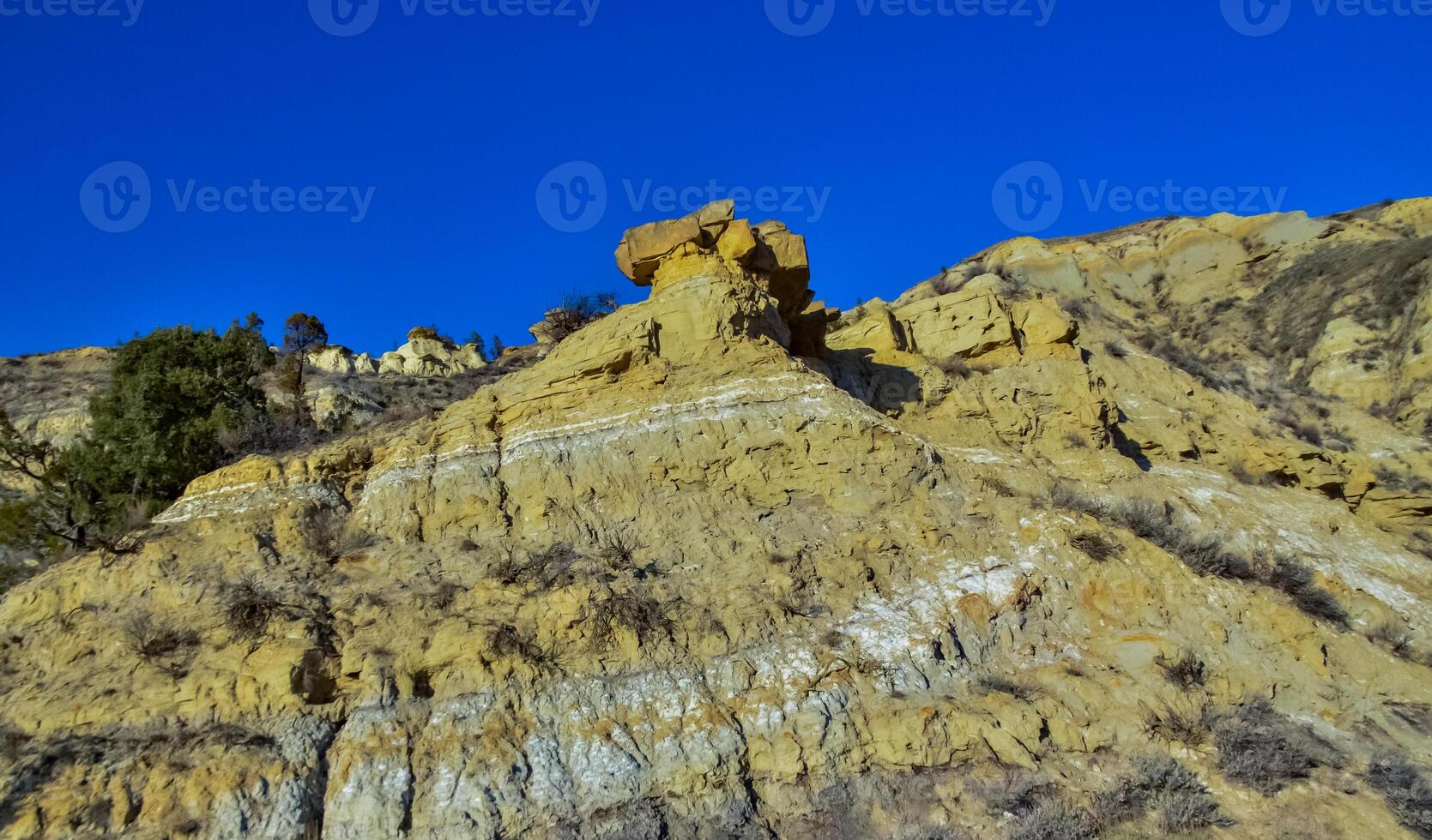 Geological stony-clay landscape, mountains and rocks in the evening at sunset. North Dakota photo
