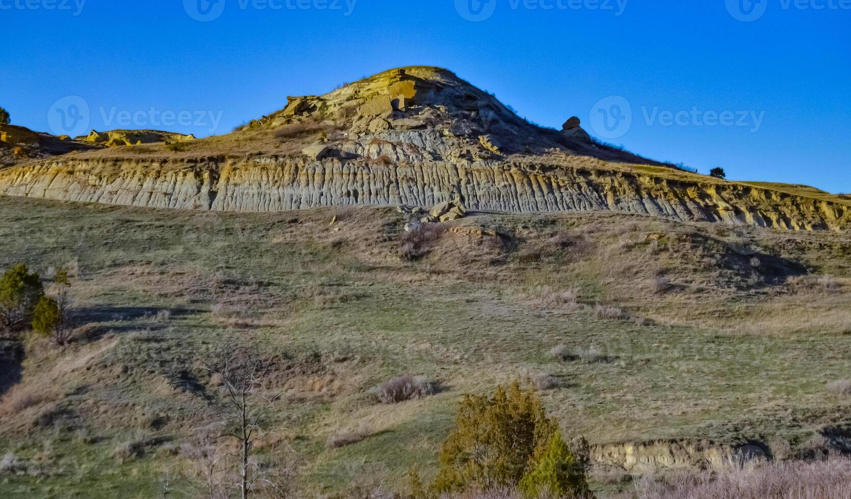 Geological stony-clay landscape, mountains and rocks in the evening at sunset. North Dakota photo