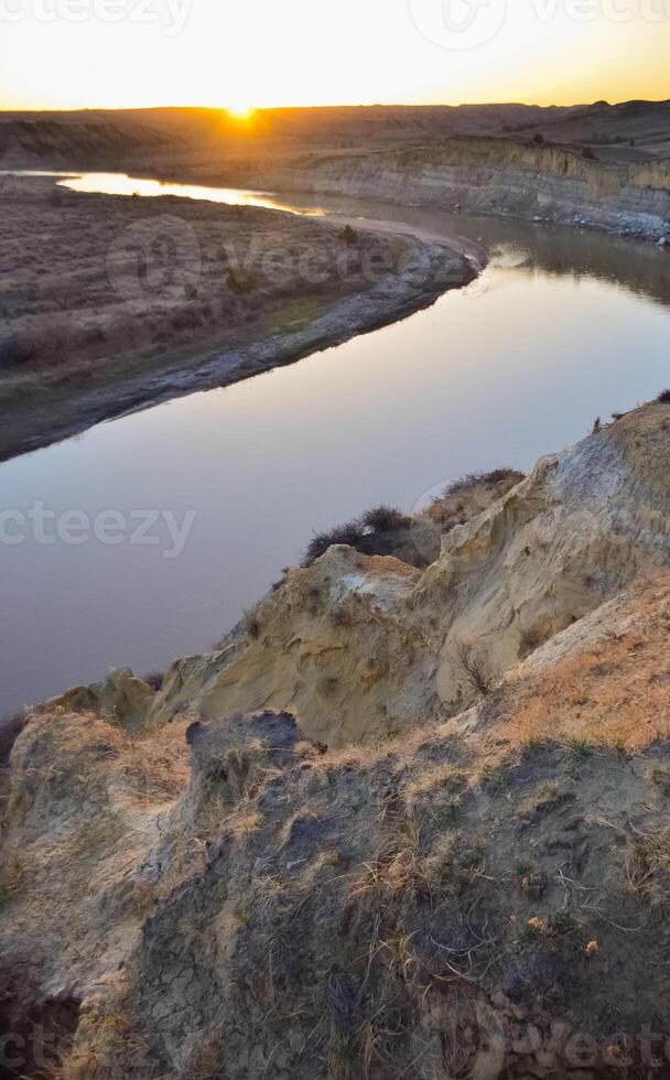 View of the winding river from the mountain in the evening at sunset. North Dakota photo