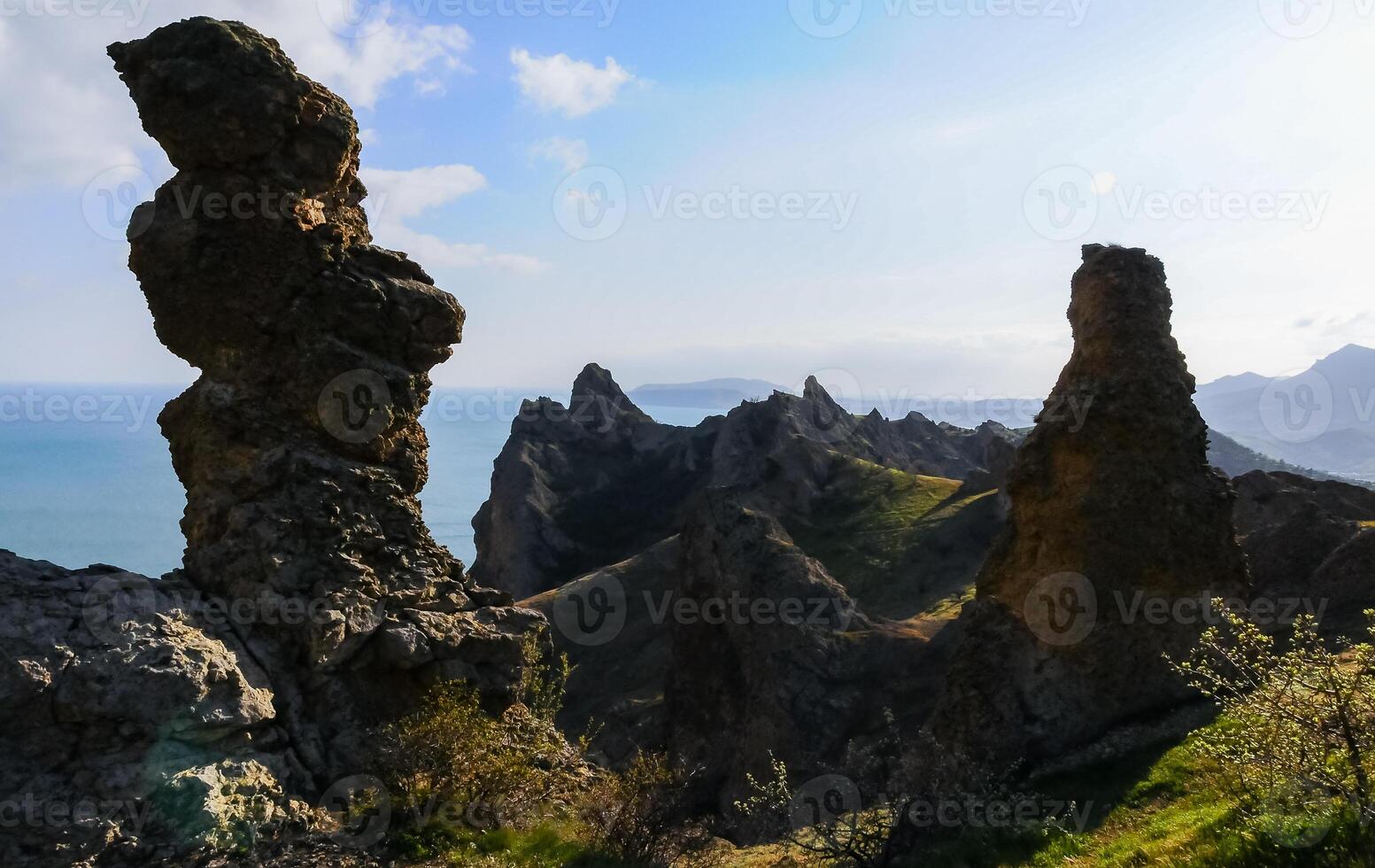 Mountain landscape, vertical weathered volcanic rocks on the slopes of the mountains photo