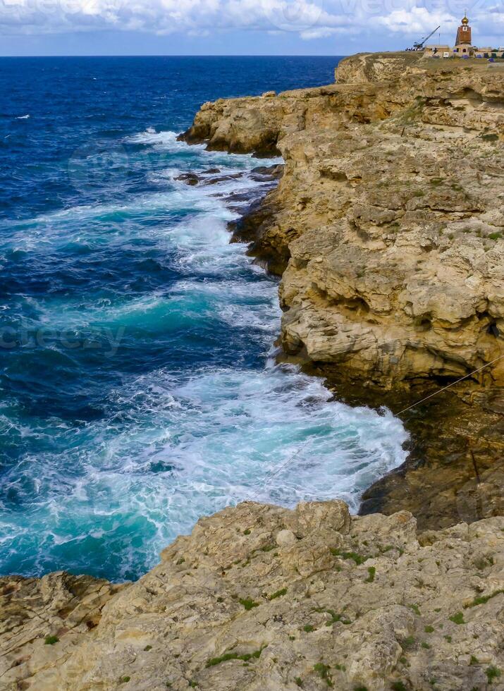 High steep stone coast during a storm in the Crimea, Tarkhankut photo