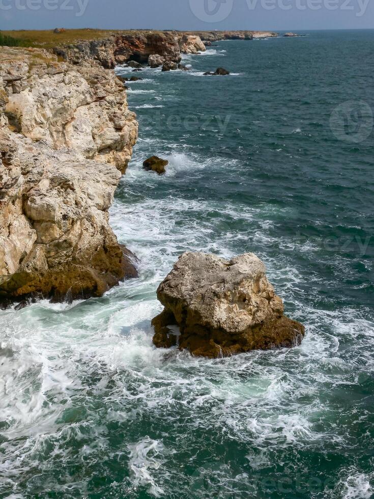 Seascape on the Black Sea, Vysoky Steep stone coast with inaccessible rocks near the village of Tyulenovo, Bulgaria photo