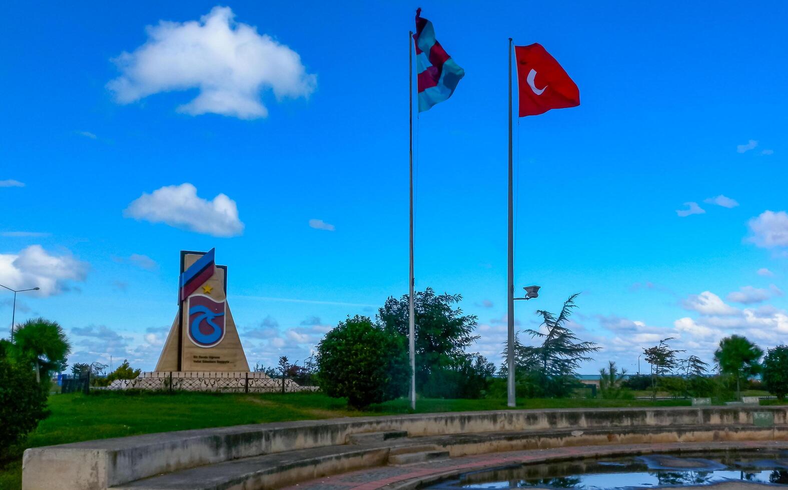 TRABZON, Turkiye - OCTOBER 22, 2014 - View of monument and Turkish flag in Trabzon, Turkiye photo