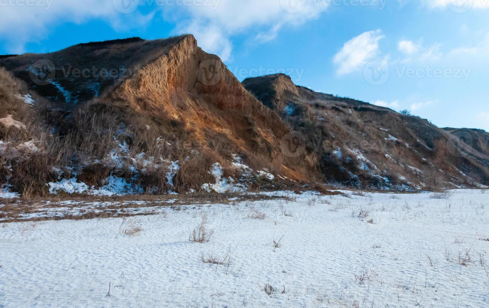 Glazed cliffs in the snow in winter on the banks of the Tiligulsky estuary, Odessa region photo