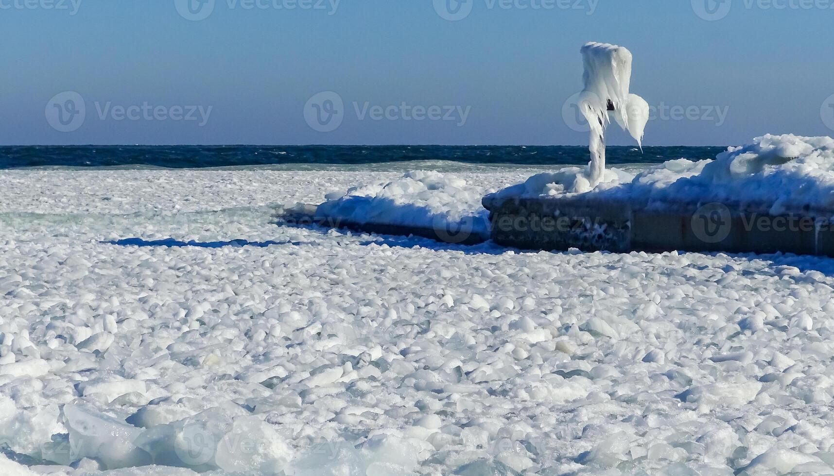 Frozen Black Sea, blocks of ice on the shore on the pier photo