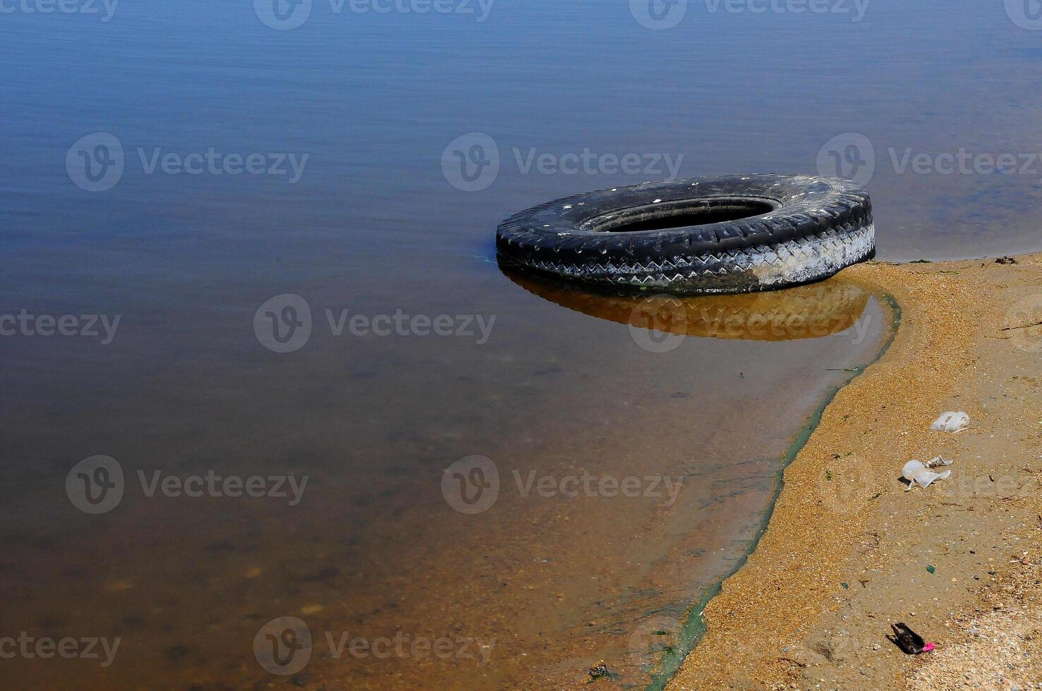 Car tires on the shore Hadzhibeysky estuary. Eutrophication of the reservoir, the problem of ecology photo