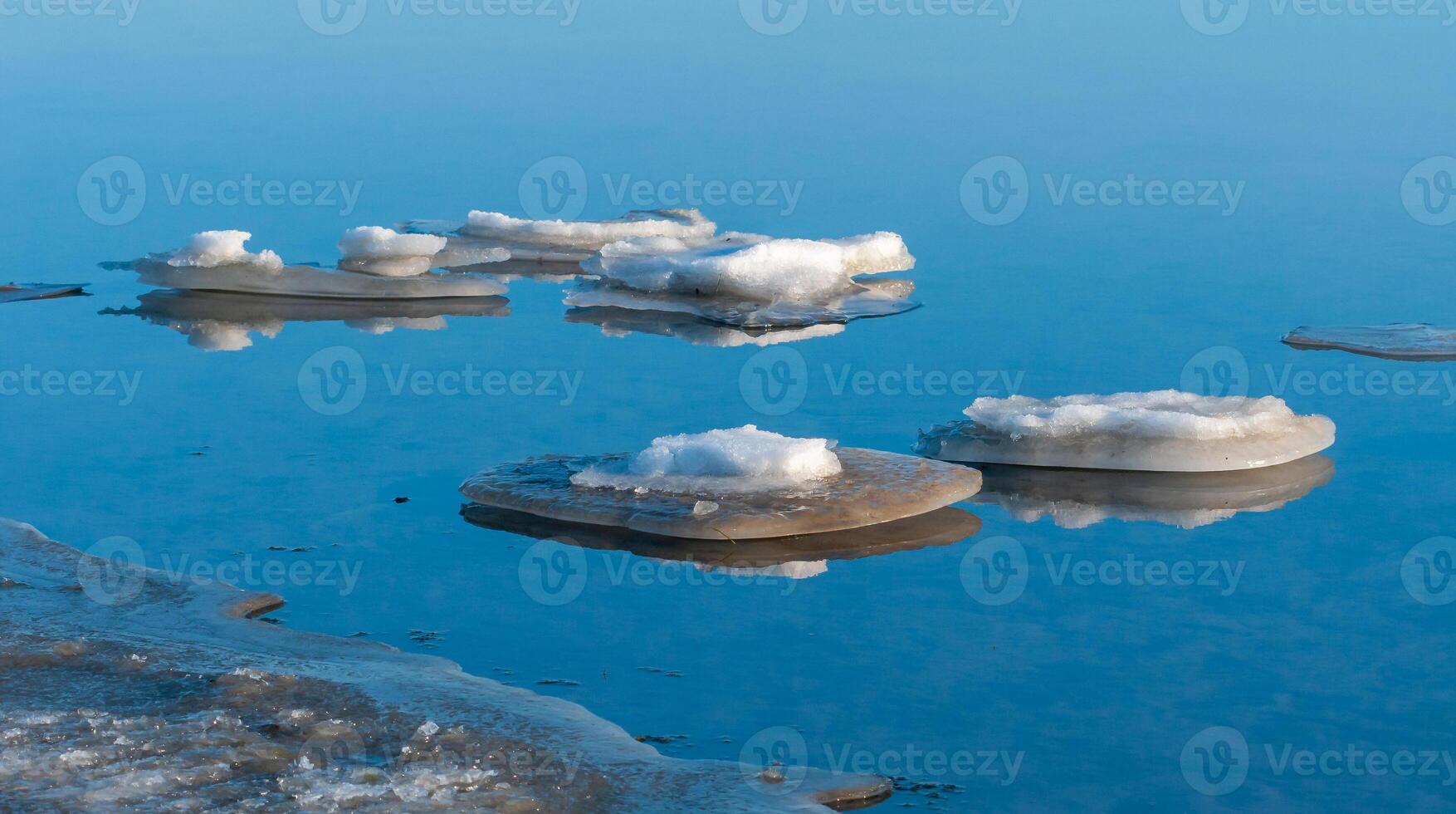Blocks of ice near the shore in the lower reaches of the Tiligul estuary on a sunny day, Ukraine photo