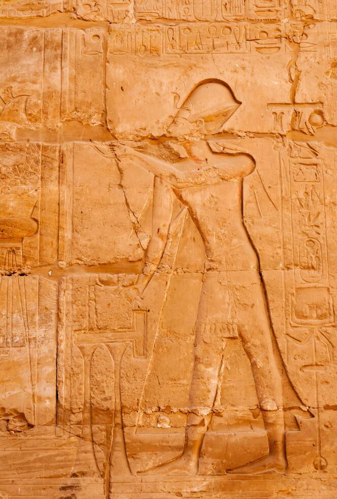 EGYPT, LUXOR - MARCH 01, 2019 ancient Egyptian hieroglyphs, drawings and inscriptions on the walls and columns in the temple of Karnak in Luxor photo