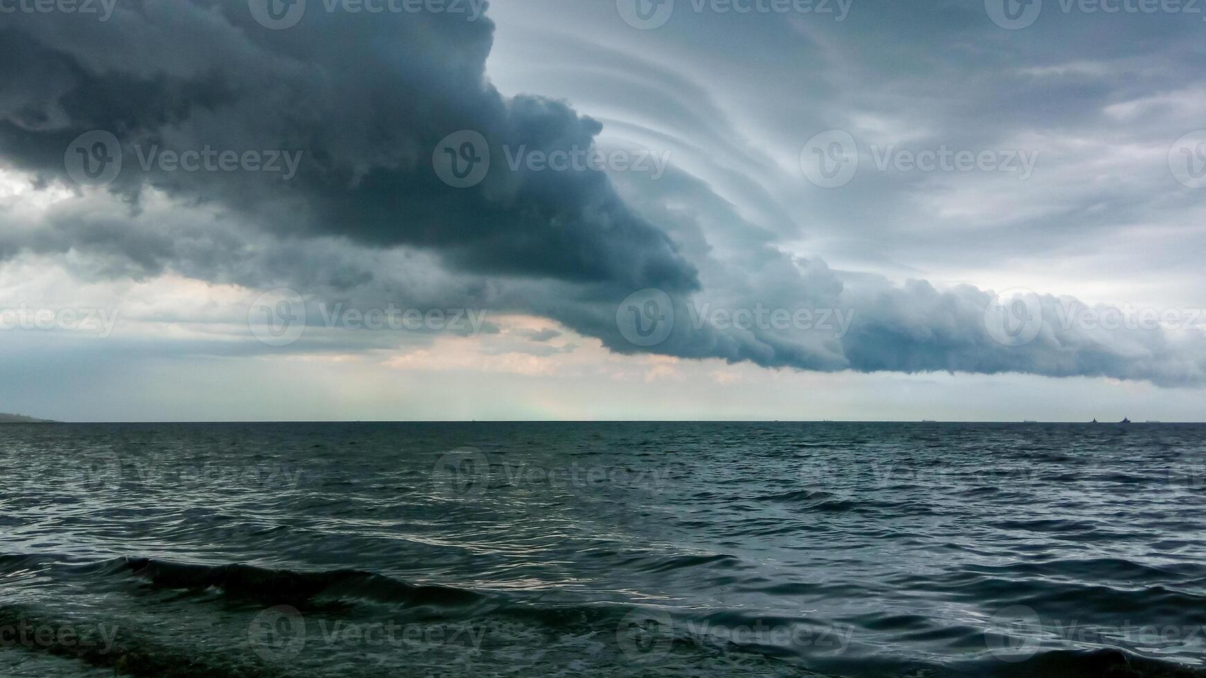 Thunderclouds over the Black Sea during blue-green algae blooms Nodularia spumigena photo