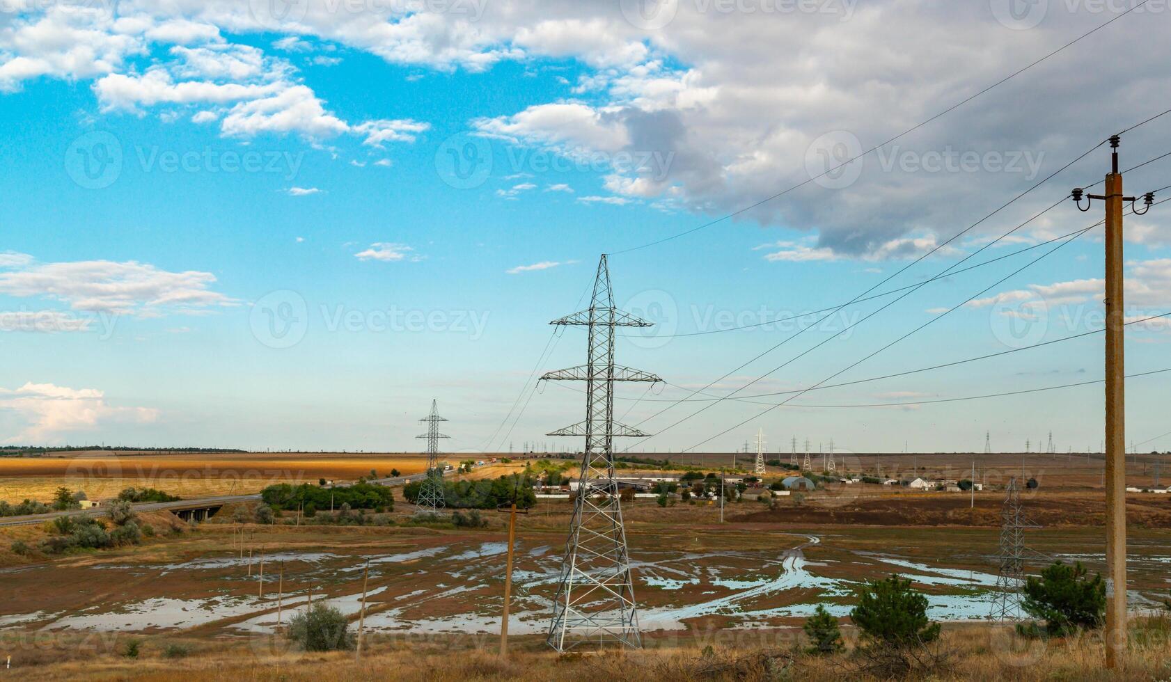 High-voltage lines on steel structures with wires against the background of the sky with clouds photo