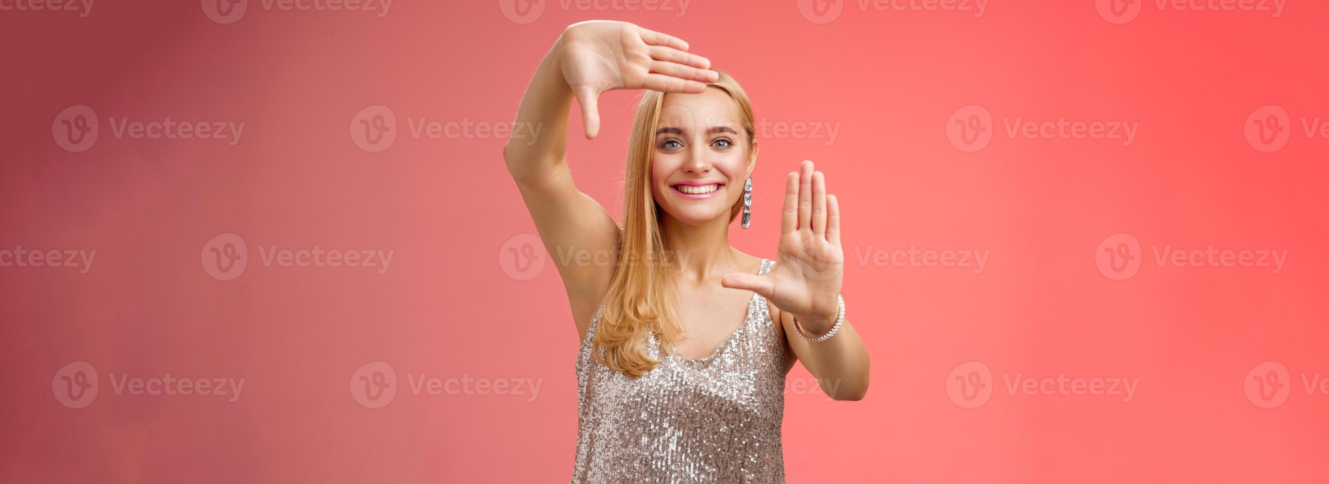 Charming creative young elegant blond female photographer blogger search inspiration picking right angle take cool shot making frames hands smiling broadly look through, red background photo