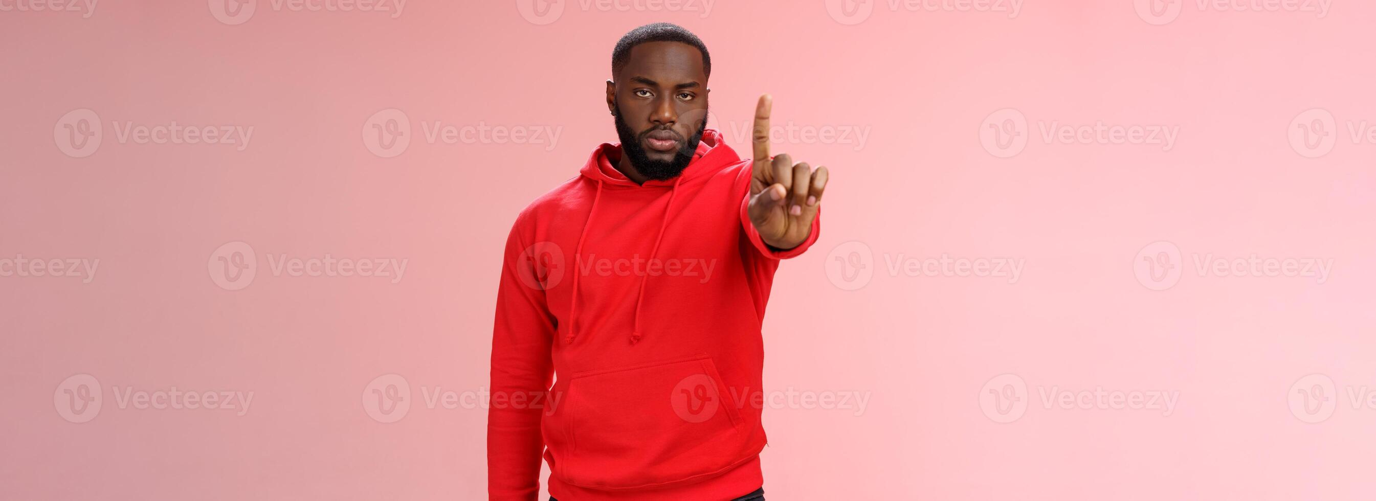 Wait second. Serious-looking annoyed strong brutal african american older brother show index finger number one explaining important rule look bossy solid, standing pink background forbid something photo