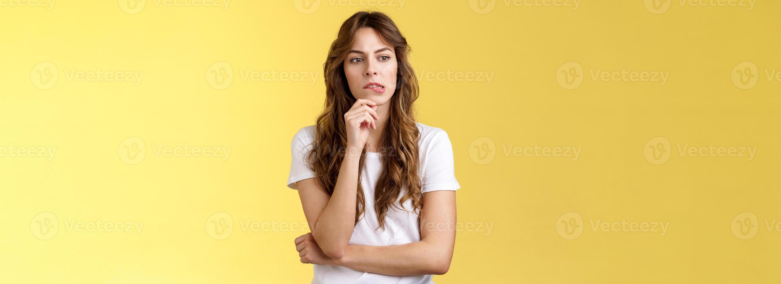 Need think what do how solve situation. Perplexed focused serious-looking thoughtful woman pouting touch lip look away pondering deep thinking standing yellow background hesitant photo
