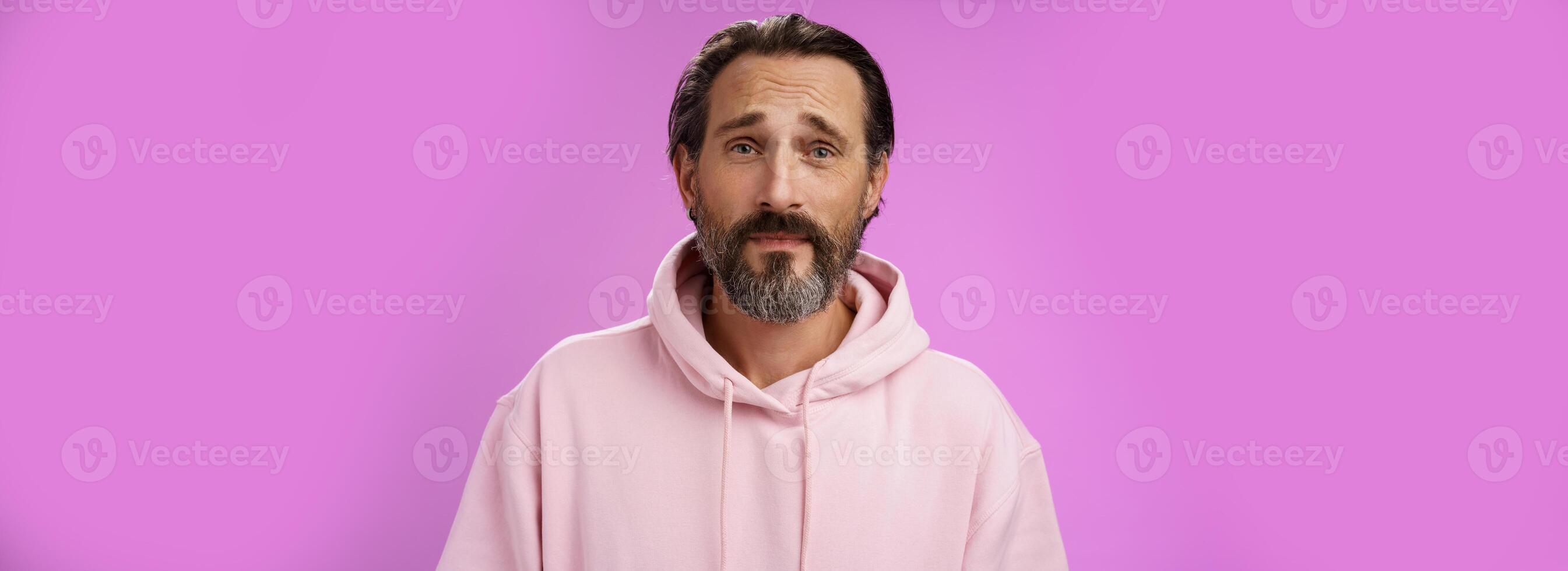 Upset worried unconfident adult bearded caucasian man grey hair frowning look hopefully nervously waiting important news, standing anxious hesitant unhappy, standing purple background unwell photo