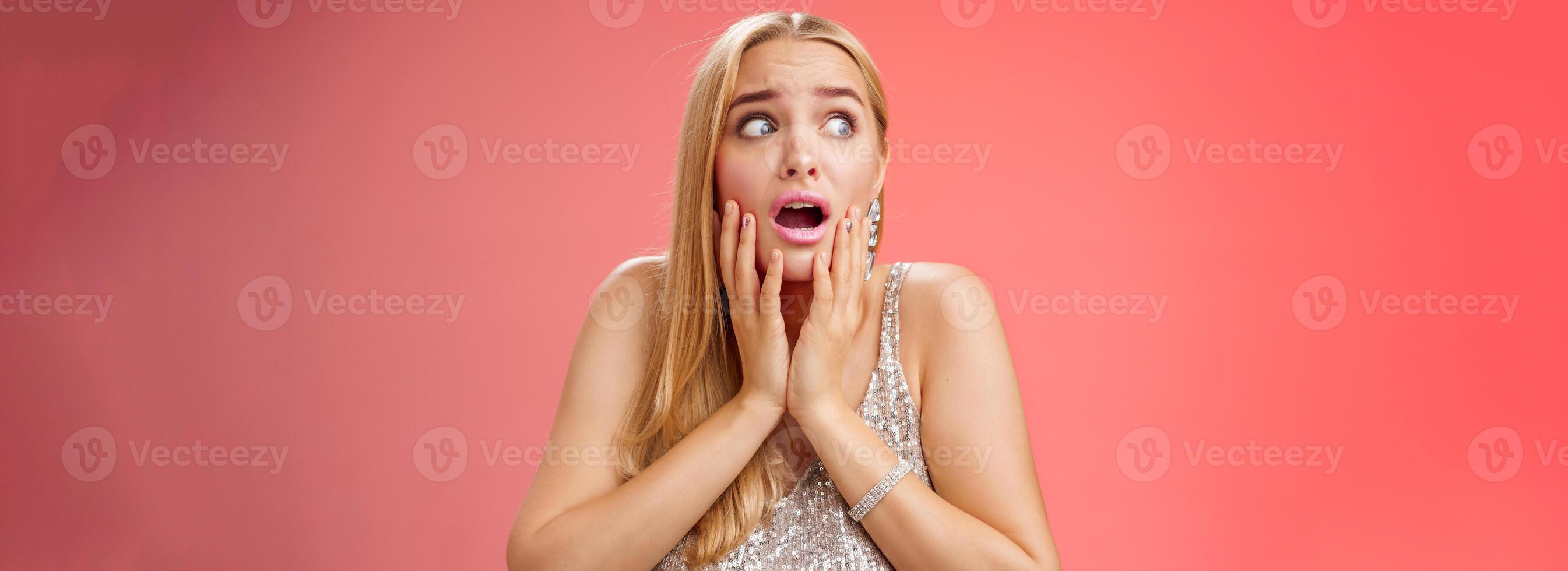 Afraid girl panic look left scared trembling fear insecure touching cheeks helpless stare sideways grimacing gasping frightened nervously waiting help, standing concerned red background photo