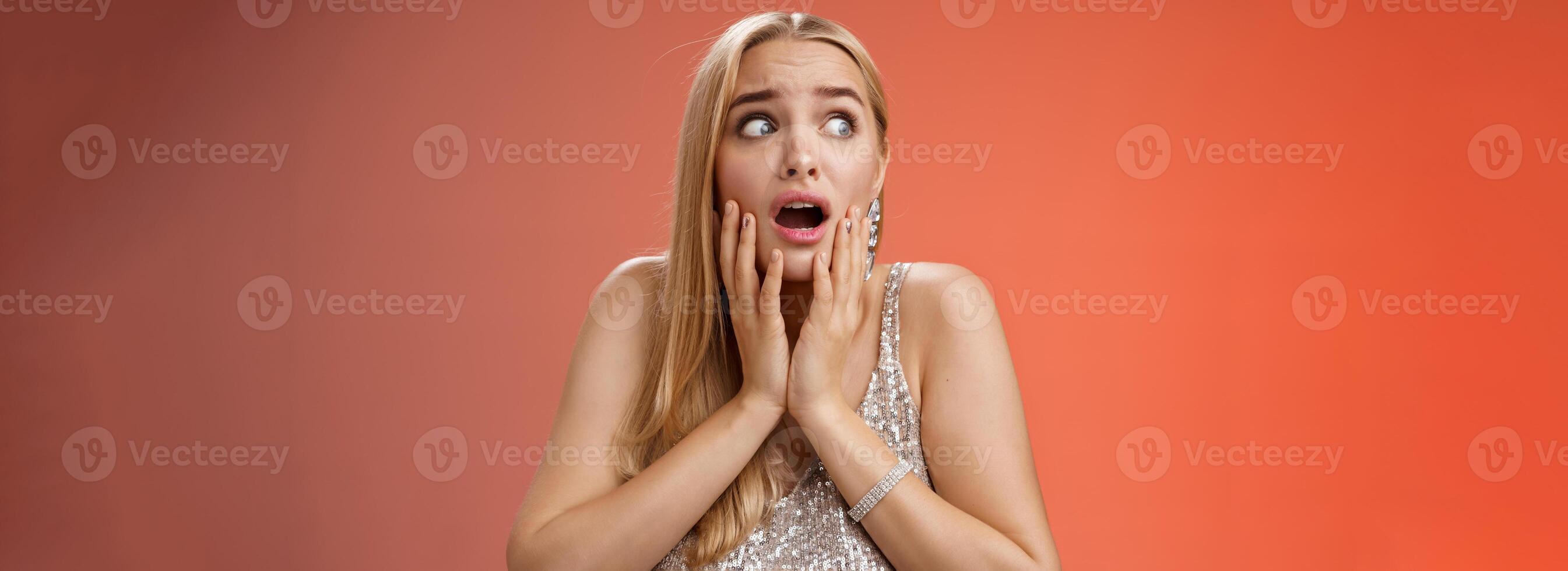 Afraid girl panic look left scared trembling fear insecure touching cheeks helpless stare sideways grimacing gasping frightened nervously waiting help, standing concerned red background photo