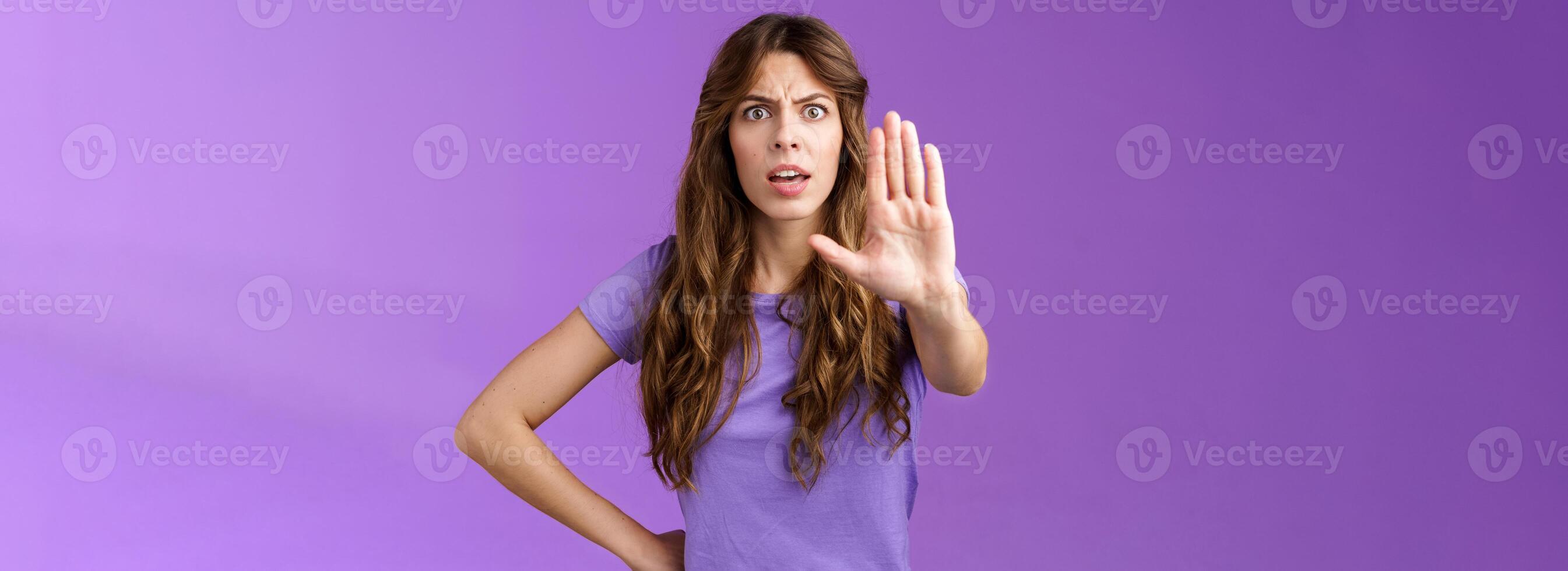 Serious-looking displeased assertive female friend stand confident demand stop smoking pull palm camera forbid disapproval gesture restrain you making bad choice purple background photo
