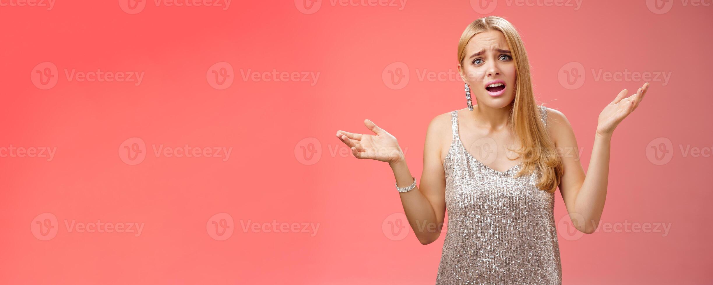 Why leaving early. Upset complaining young attracitve bothered blond woman complaining look questioned disappointed raise hands up sideways dismay clueless frowning displeased, red background photo