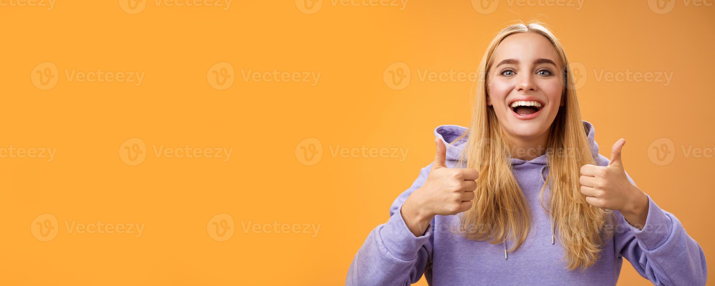 Supportive cute blond girlfriend cheering liking interesting concept cool idea thumbs-up smiling broadly agree approve outfit shopping together friends, recommend adore new look, orange background photo