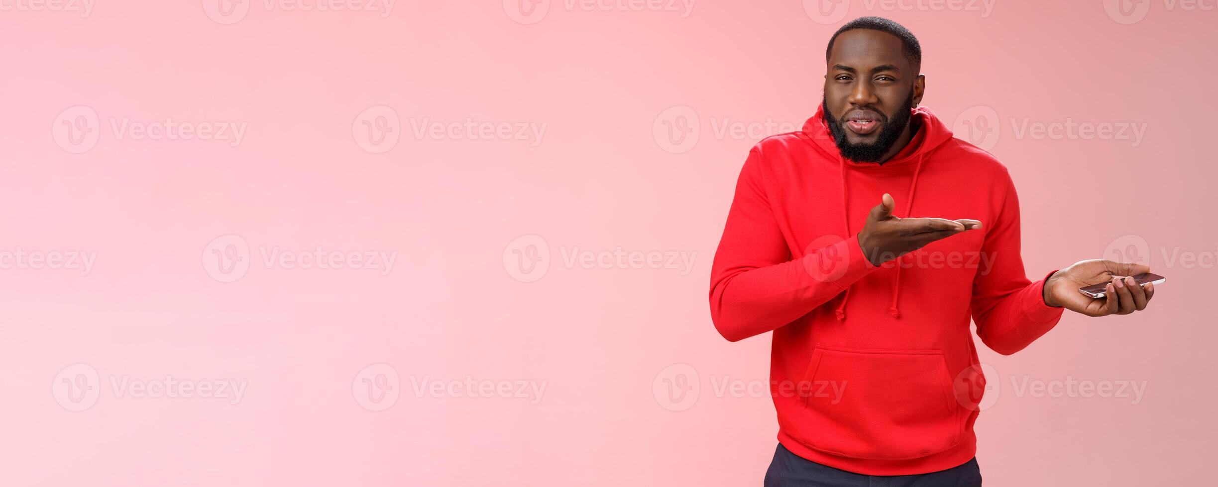 Guy complaining strange text received from girlfriend asking friends advice holding smartphone pointing palm device look frustrated questioned, man confused ridiculous message, pink background photo